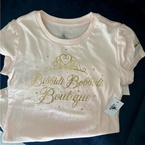 NWT Disney "Bibbidi Bobbidi Boutique" girls tee with gold glitter graphic.